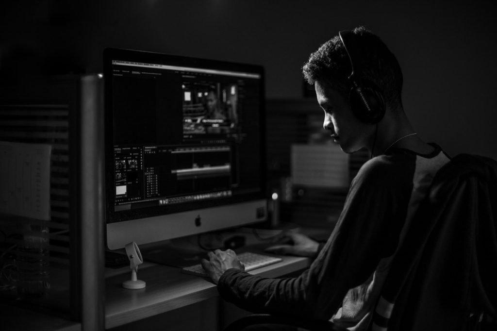 adult-sitting-at-desk-with-apple-computer-adult-apple-black-and-white-2330137