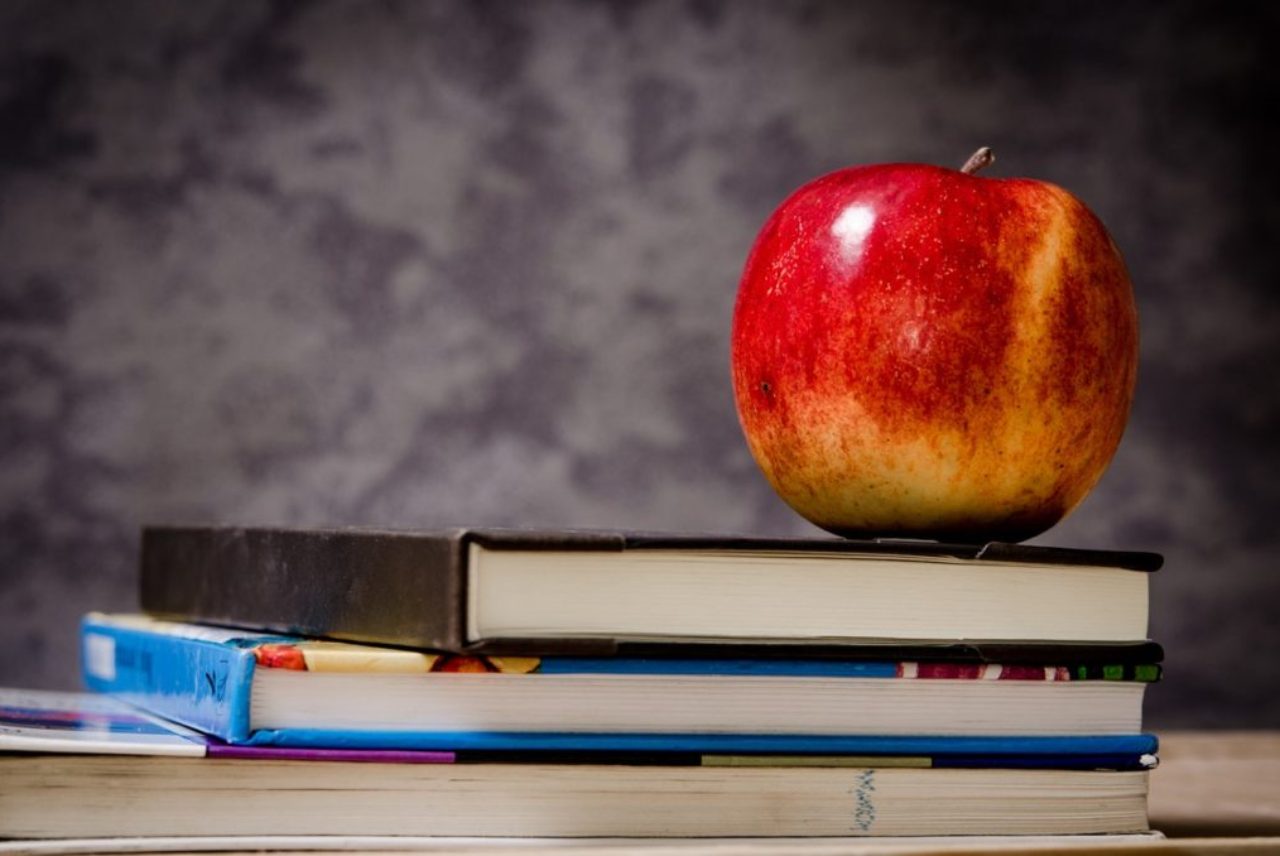 close-up-of-apple-on-top-of-books-256520